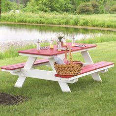 a picnic table set up in the grass near a tree