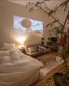 a bedroom with a large screen on the wall