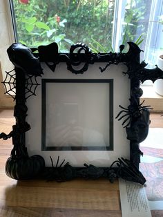 a spider web frame sitting on top of a wooden table