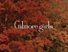 the words'glimmore girls'are in front of trees with red leaves