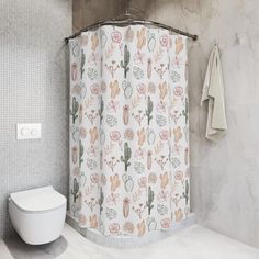 a white toilet sitting next to a shower curtain