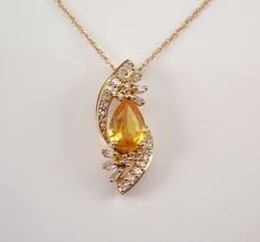 Yellow Gold Yellow Sapphire and Diamond Pendant with Chain. This gorgeous pendant is set in the center with a Pear Shaped Yellow Sapphire. This Sapphire is 100% Natural, measures 7 X 5 mm and weighs 3/4 carat.  There are also twenty-four Round Brilliant Diamonds and six Baguette Diamonds set throughout this pendant. These diamonds are H color, SI/I clarity and weigh a total of .20 carat. This pendant is 10K Yellow Gold and comes with an 18" 10K Yellow Gold chain and together weigh 2.0 grams. Thi Necklace Unique, Yellow Gold Chain, Yellow Sapphire, Fine Jewelry Gift, Baguette Diamond, Gia Certified Diamonds, Beautiful Gift Boxes, Unique Necklaces, Diamond Pendant