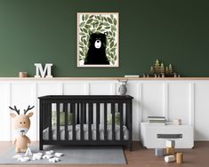 a baby's room with green walls and pictures on the wall, including a crib