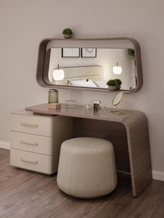 a vanity with a mirror and stool in the corner next to a wall mounted lamp