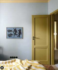 a bedroom with blue walls and yellow doors