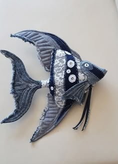 a fish made out of fabric with buttons on it