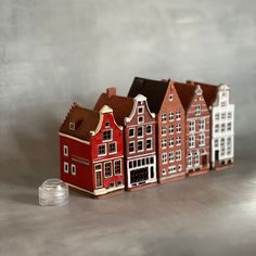 a row of red and white buildings sitting on top of a table