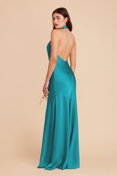 the back of a woman in a teal gown