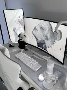 a computer desk with two monitors and headphones on it's sides, along with a stuffed animal