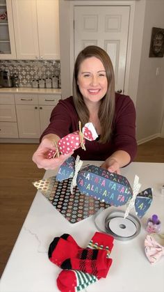 a woman sitting at a table with some items in front of her and smiling for the camera