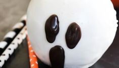 there is a cake decorated to look like a ghost with chocolate eyes on it's face