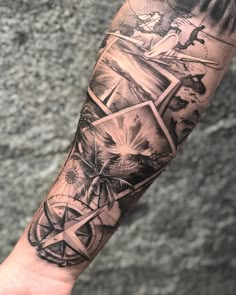 a man's arm with tattoos on it and an image of a compass in the middle