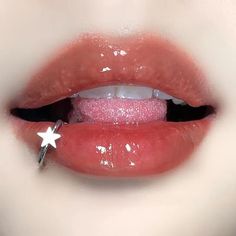 a close up of a person's lips with pink glitter on them and a star pin in the middle