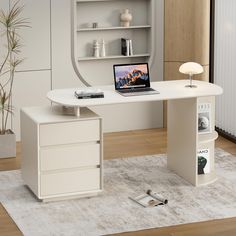 a white desk with a laptop on it