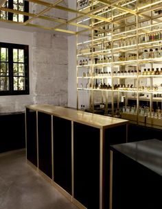 an empty bar with lots of bottles on the shelves