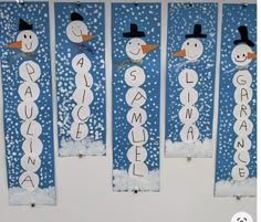 three snowmen are hanging on the wall