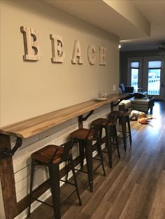 the bar is lined with wooden stools and letters that spell out bleach