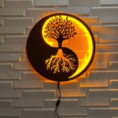 a lamp that has a tree on it and a yin - yang symbol in the middle