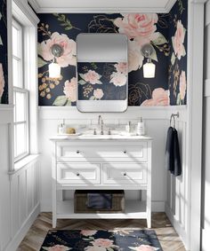 a bathroom with floral wallpaper and white vanity, mirror, and rug on the floor