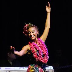 a woman in a colorful dress dancing on stage