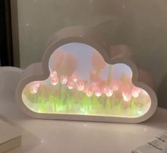 there is a cloud shaped light up with flowers on it