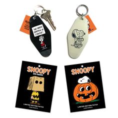 three keychains with cartoon characters on them, one for snoopy and the other for peanuts