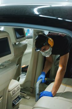 a man cleaning the inside of a car