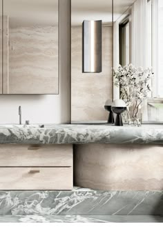 a bathroom with marble counter tops and cabinets