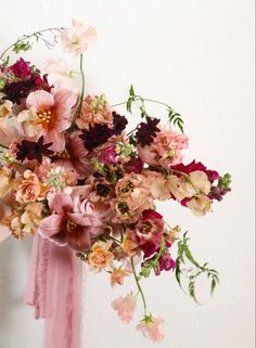 a bouquet of flowers is hanging on the wall