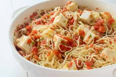 a white bowl filled with pasta and tofu