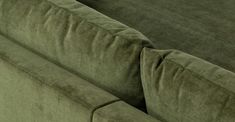 a close up view of the back end of a green couch