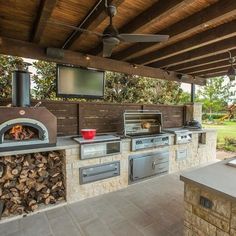 an outdoor kitchen with wood burning ovens