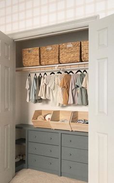 an organized closet with clothes and baskets