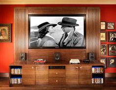 a large television mounted to the side of a wooden entertainment center