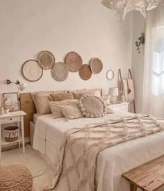 a bedroom with white walls and lots of plates on the wall