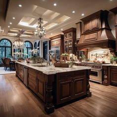 a large kitchen with an island and chandelier