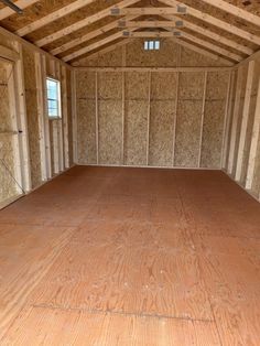 an empty room with wood flooring and walls in the house that is being built