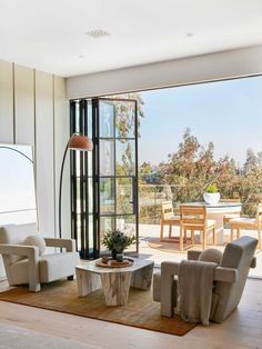 a living room with large windows and furniture