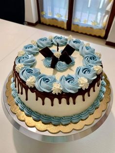 a blue and white cake sitting on top of a table