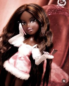 a barbie doll with long brown hair wearing a pink dress and white gloves, holding a cell phone in her hand