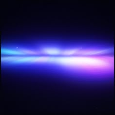 an image of some blue and purple lights in the dark night sky with no clouds