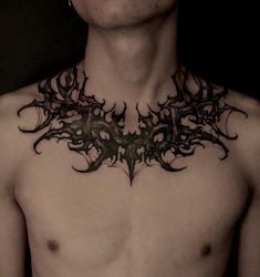 a shirtless man with an intricate design on his chest