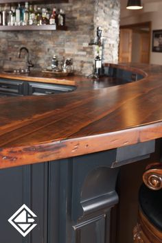 a wooden counter top in a kitchen next to a bar