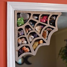 a mirror that has some rocks in it and is hanging on the side of a wall