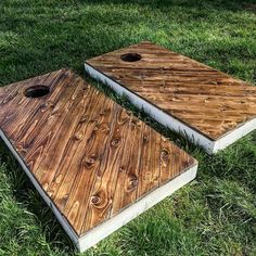 two wooden boards sitting in the grass