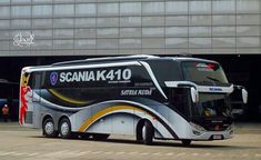 a large bus parked in front of a building