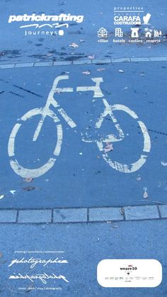 an advertisement for a bicycle parking space on the sidewalk with white paint and graffiti written on it