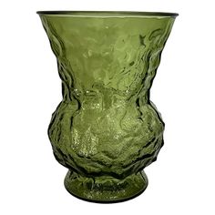 a green glass vase sitting on top of a table