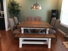 a dining room table with benches in front of it