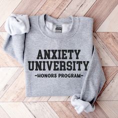 Anxiety University Honors Program Sweatshirt - Mental health crewneck in college font design. Hoping for a T-SHIRT?  Wish I had a different COLOR or SIZE?  Please ask!  I will do my best to accommodate! About Our Sweatshirts Ideal for any situation, this premium and soft Unisex sweatshirt fits like a well loved favorite.    .: Ribbed knit collar retains its shape even after washing  .: No itchy side seams  .: 50% Cotton 50% Polyester - A perfect blend for smooth printing .: Medium-heavy fabric Vinyl Sweatshirt Ideas Cricut, Positive Sweatshirts, Sarcastic Sweatshirts, Popular Sweatshirts, Sweatshirt And Shirt Outfit, Sassy Sweatshirts, Masters Program, College Font, College Sweater